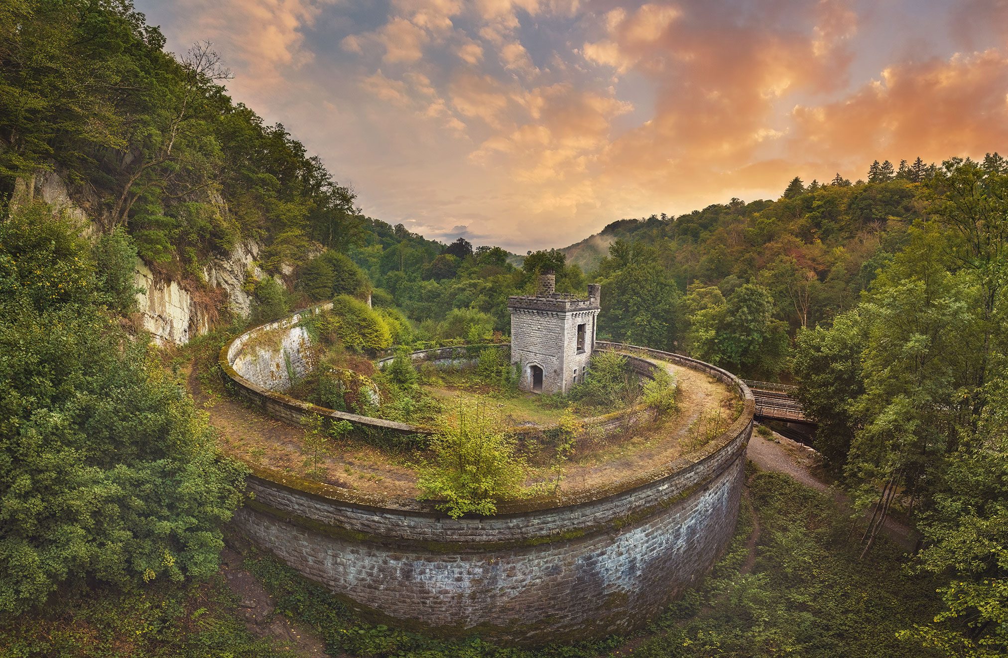 Former railway installation with a circular embankment and tower in the Ardennes valley, Belgium