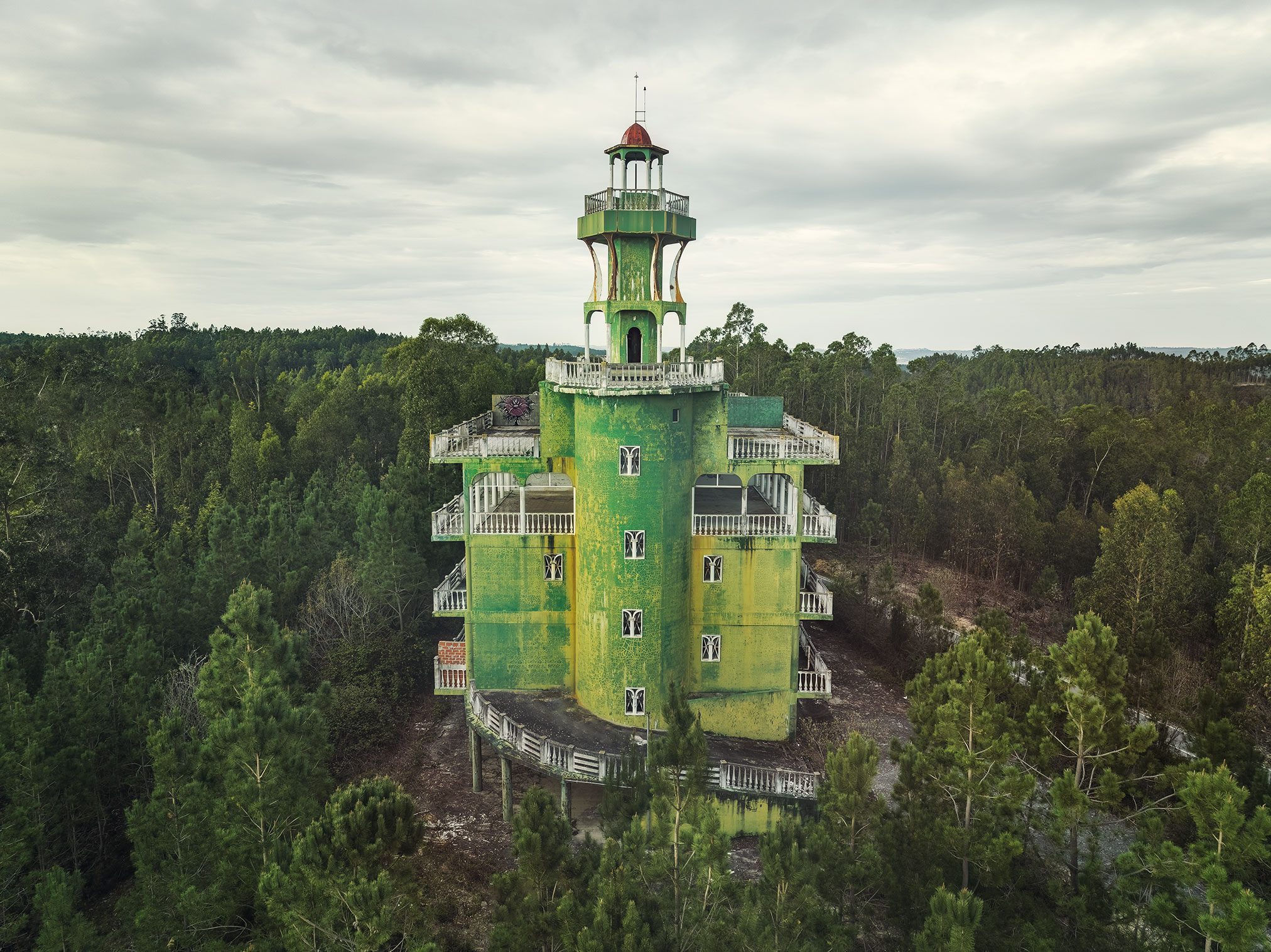 Green painted tower hotel in a pine forest in Portugal