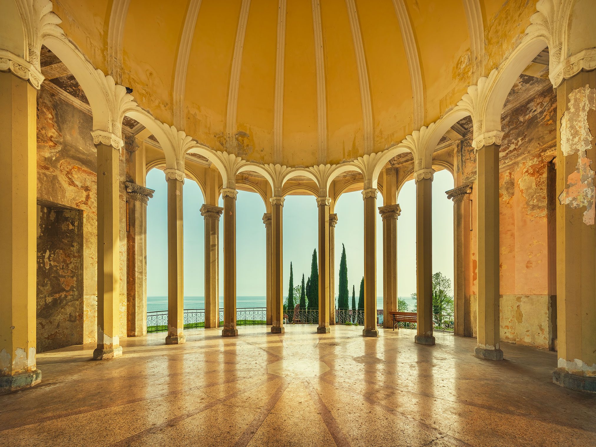 Round colonnaded hall with a sea view in an abandoned building