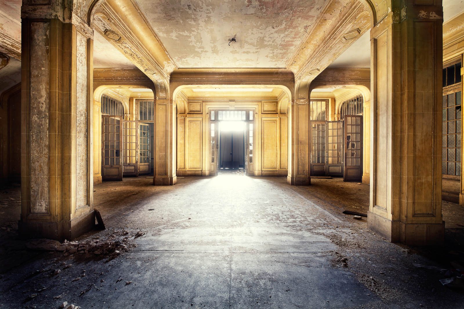 Columned hall with light-filled glass doors in an administrative building in France