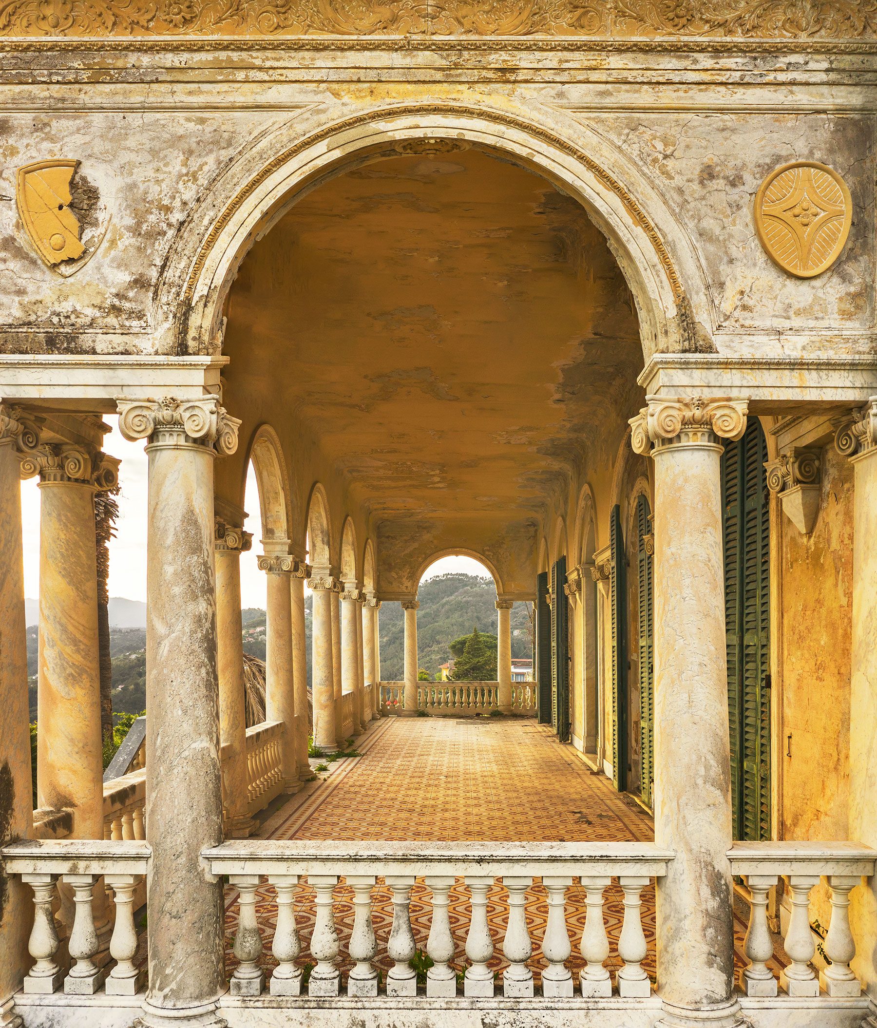 Loggia with Ionic columns and heraldic medallions on the Ligurian coast, Italy