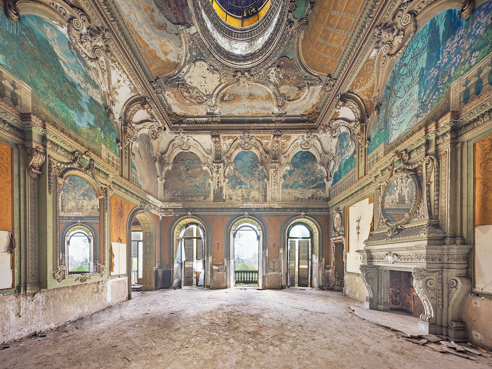 Fresco-decorated hall with landscape painting and a fireplace in a palazzo in Turin, Italy