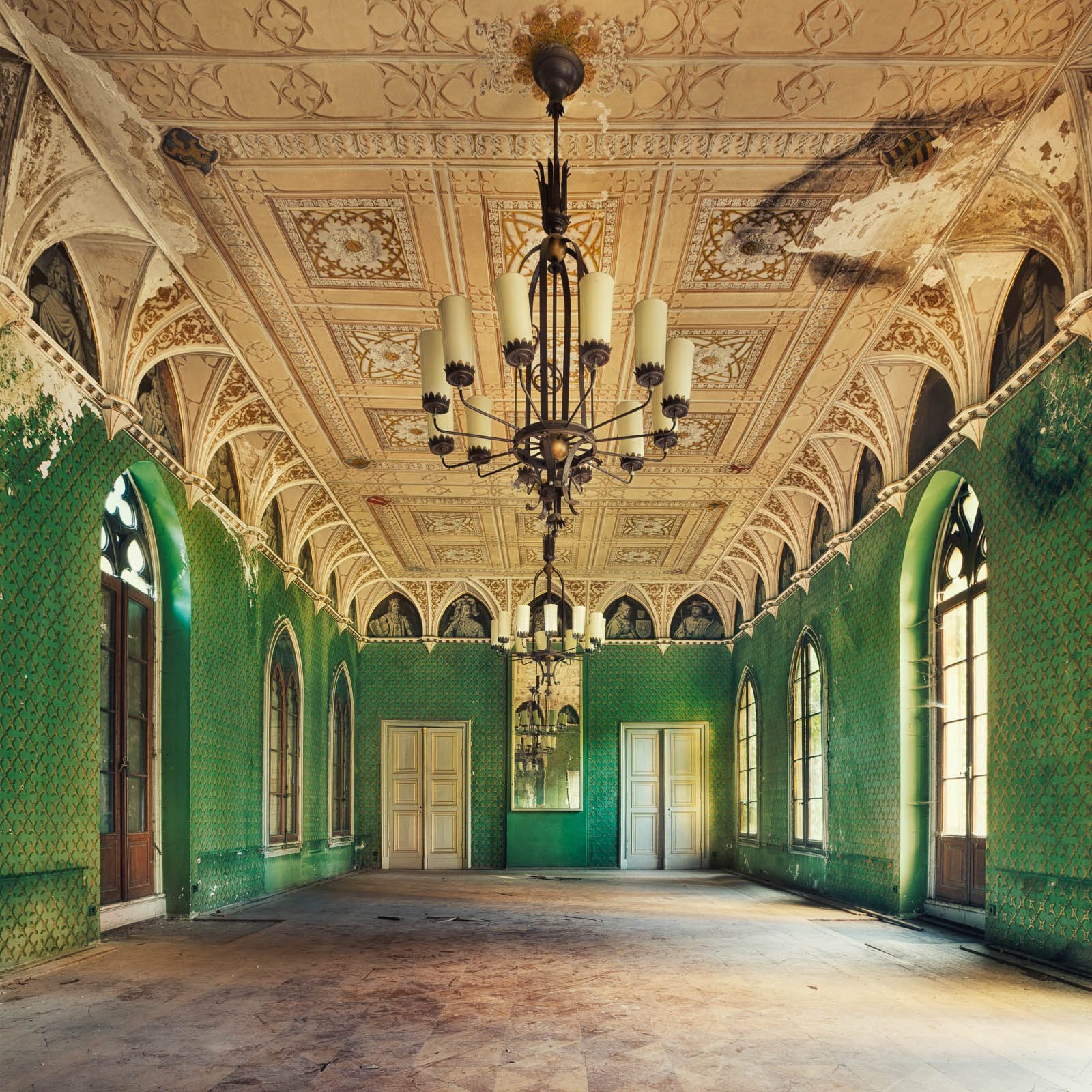 Grüner Festsaal mit Rippengewölbe und Kronleuchter in einem Schloss in Deutschland