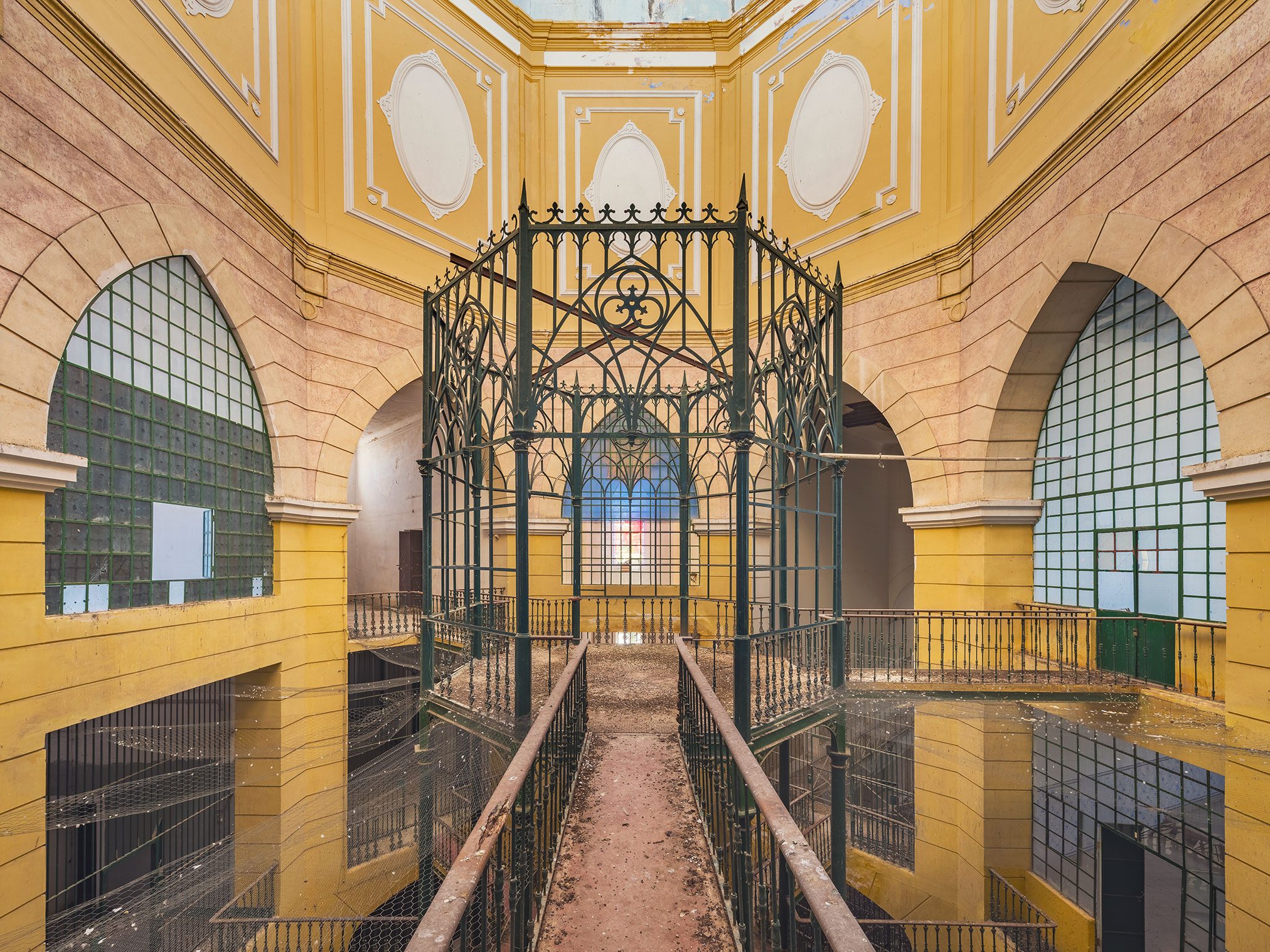 Octagonal hall with a wrought-iron watch structure in an abandoned prison in Portugal