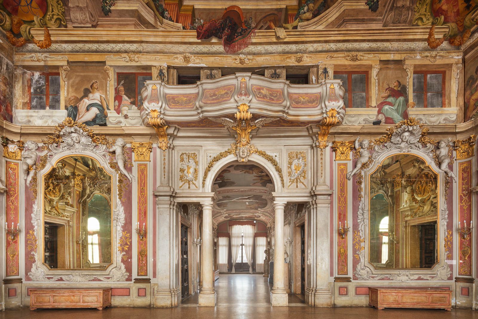 Hall of mirrors with a framed archway in Palazzo Zenobio, Venice, Italy