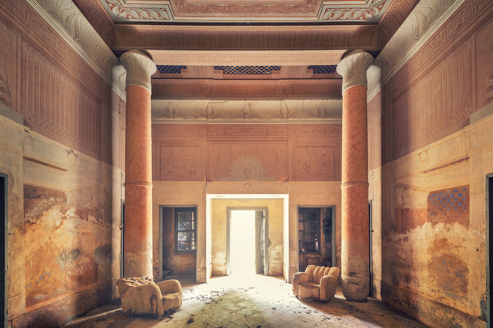 Symmetrical hall with an Egyptian-style frieze in a forgotten villa in Veneto, Italy