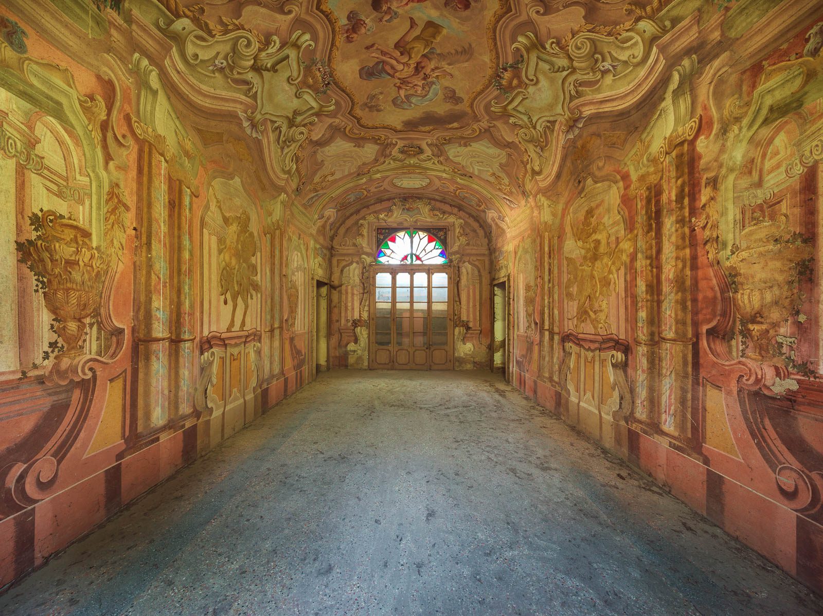 Rococo entrance hall with a ceiling fresco and a stained-glass door in a villa in Lombardy, Italy