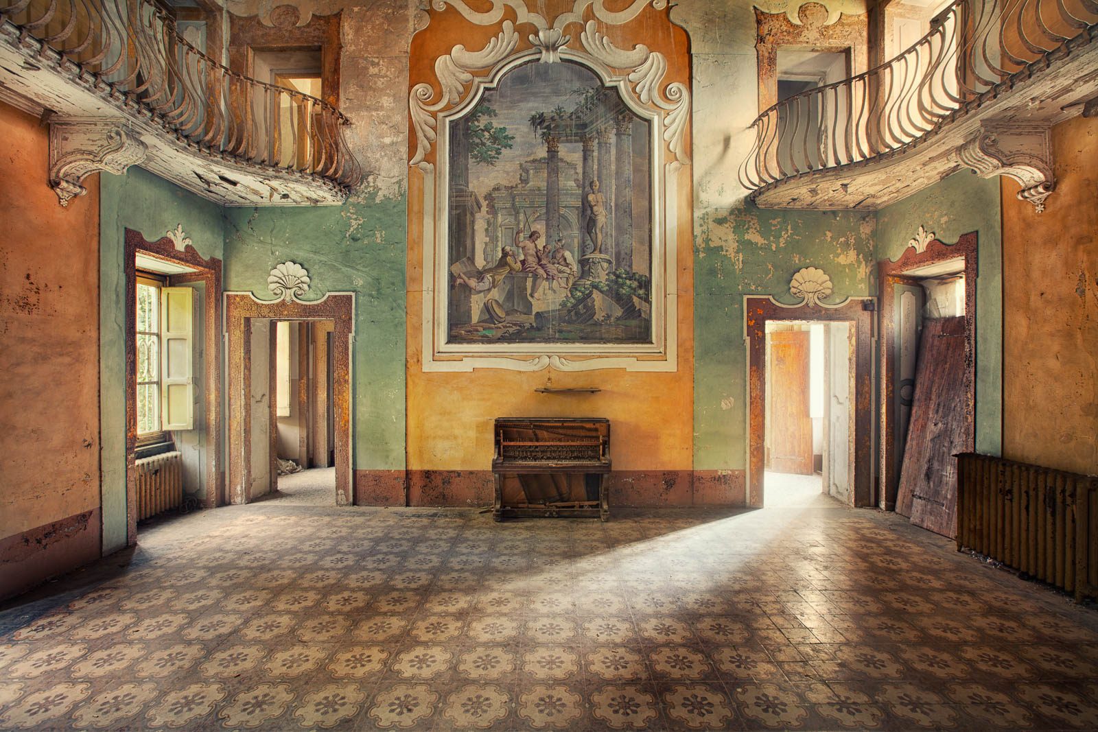 Ballroom with a painted mural and two balconies in a villa in Tuscany, Italy