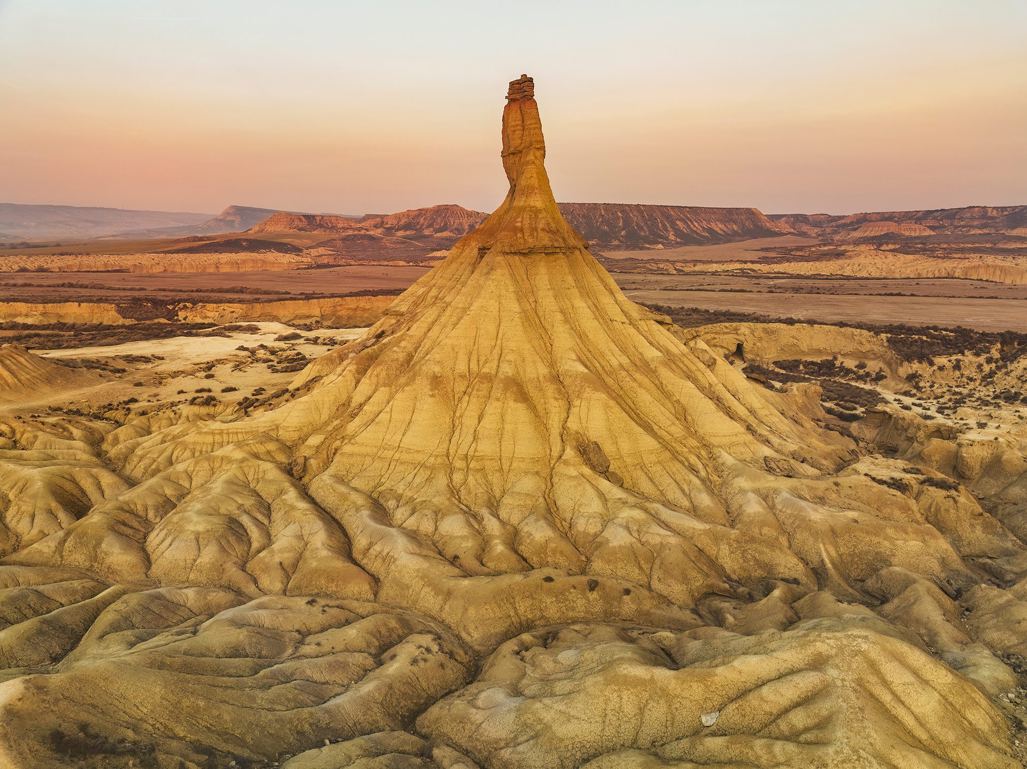 An erosion cone in the Bardenas Reales badlands at dusk, Spain