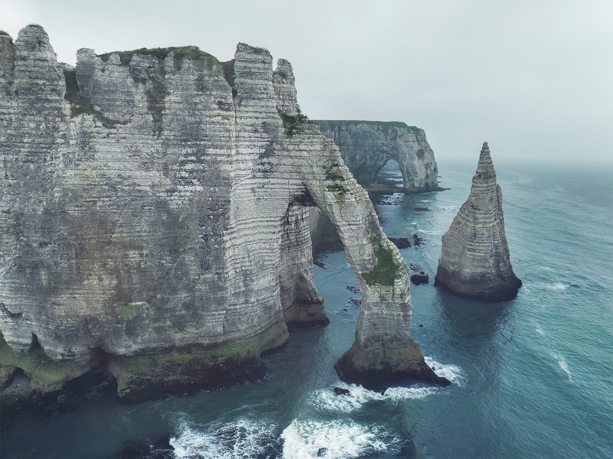 Chalk cliffs with a natural arch and rock needle at Étretat, France