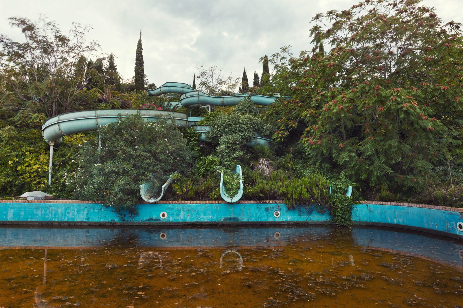 Overgrown water slides of an abandoned water park on the Adriatic coast, Italy