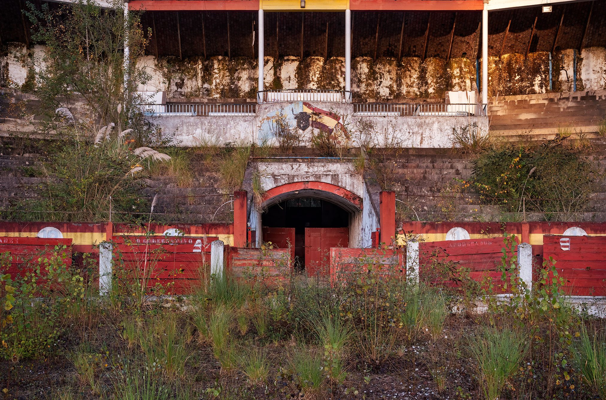 Abandoned bullring with red barrier in Spain