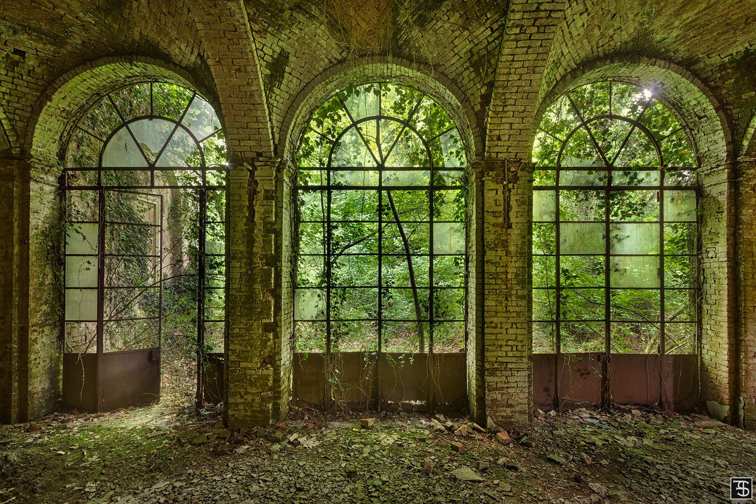 Arcade with a view into the garden of a palazzo in Piedmont, Italy