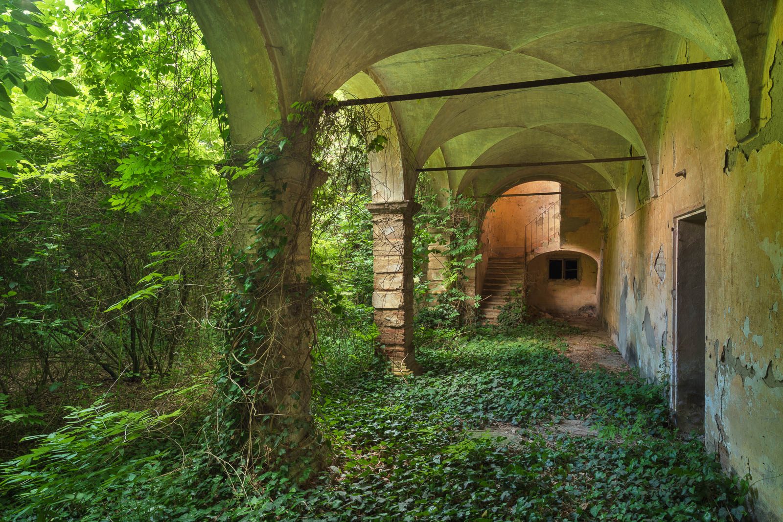 Vaulted corridor with a view of a staircase in a palazzo in Lombardy, Italy