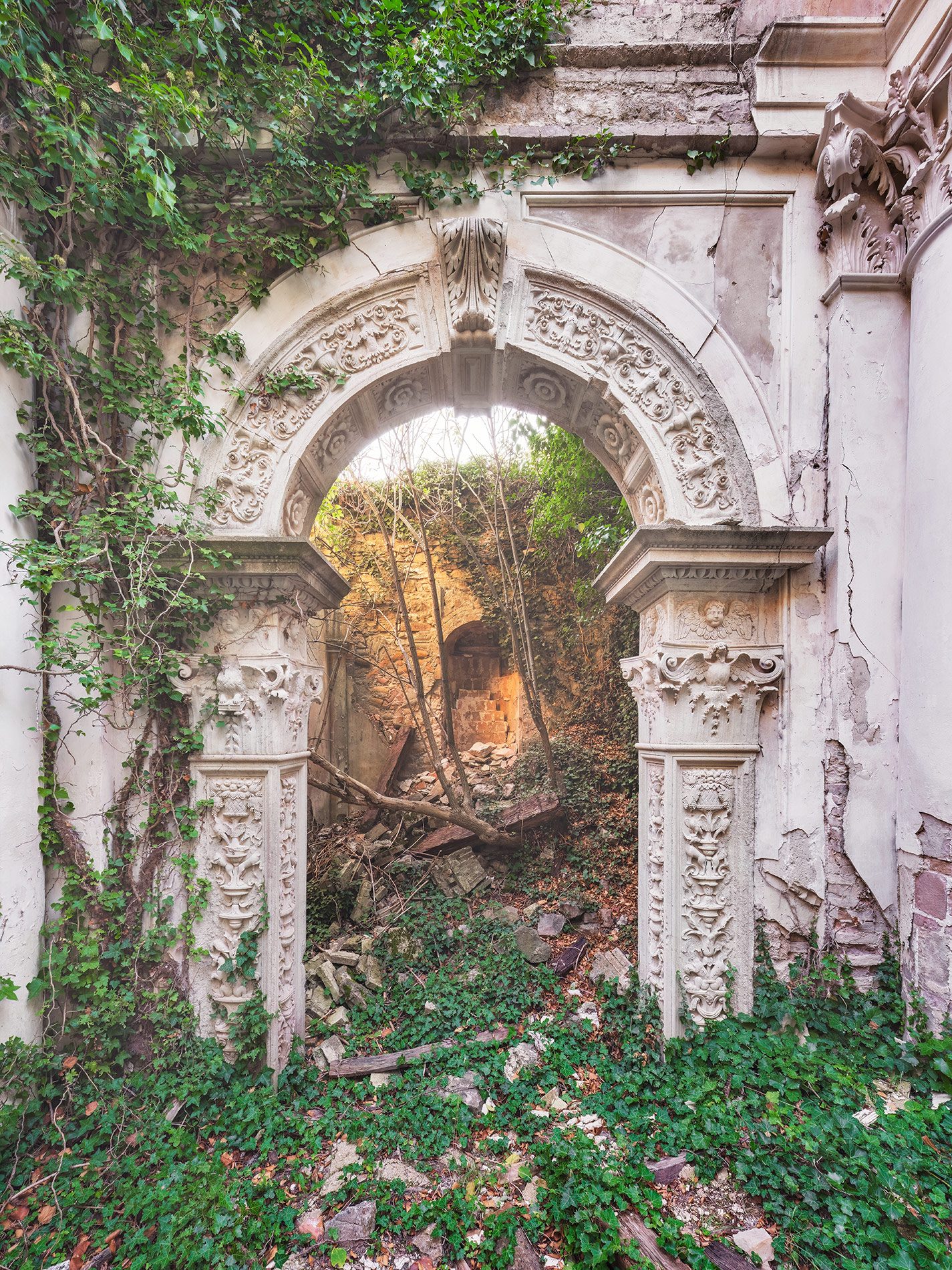 Ornate stone portal in a ruined church in Italy