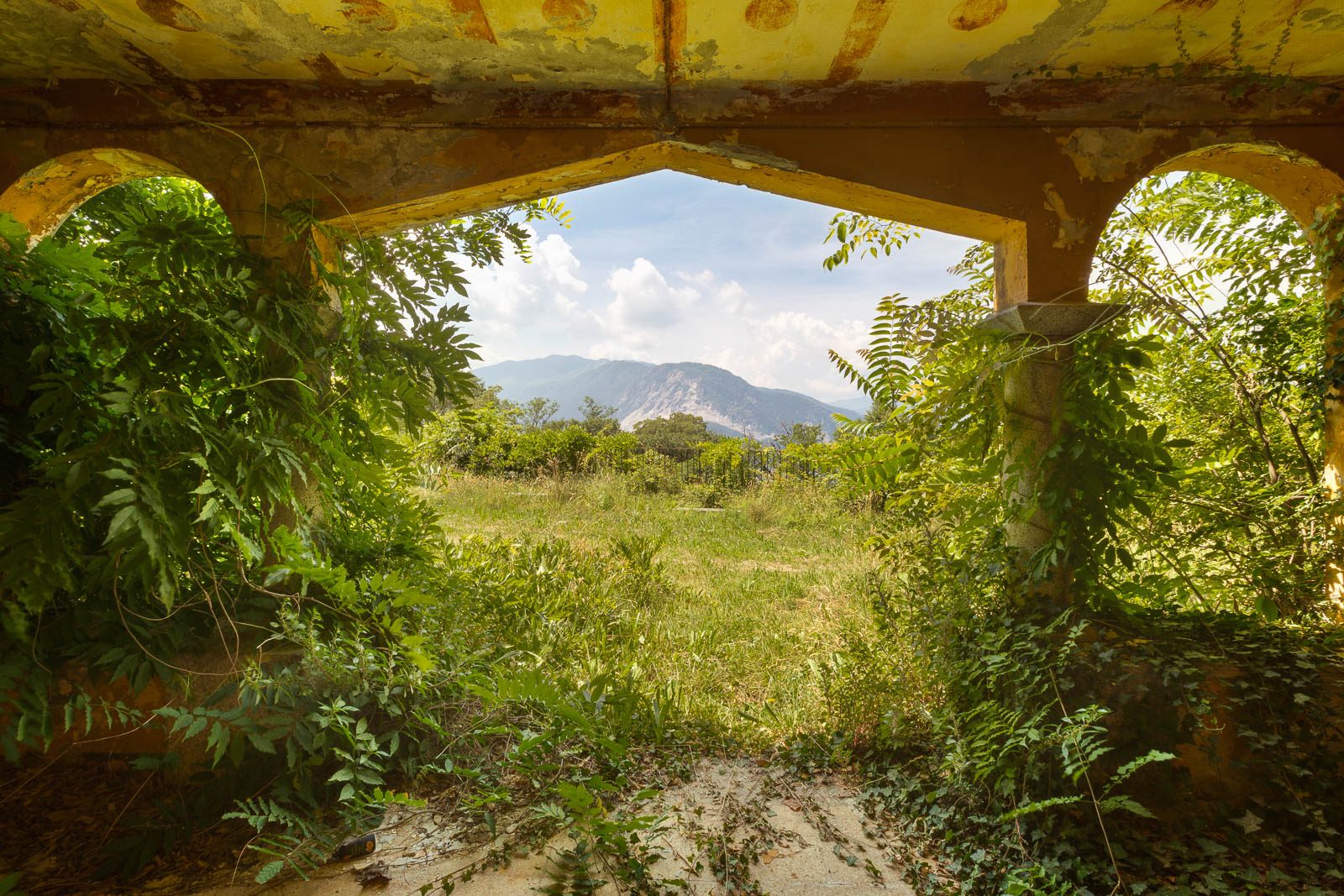 Mountain view through an arch of an old holiday camp on Lake Maggiore, Italy