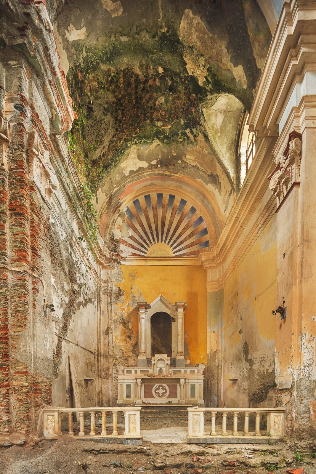 Forgotten church with sun painting above the altar in Italy