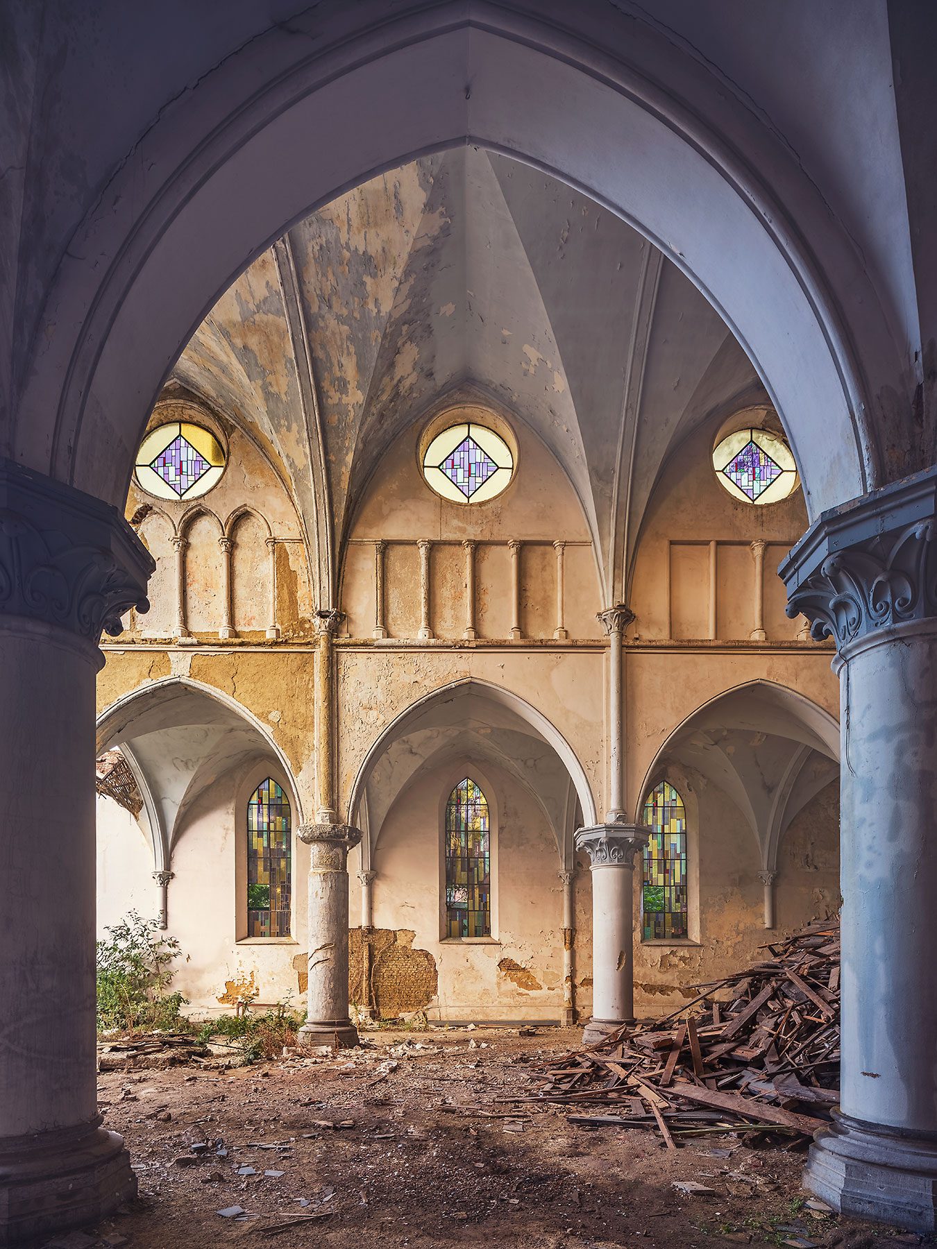 Abandoned church with round stained glass windows in Belgium