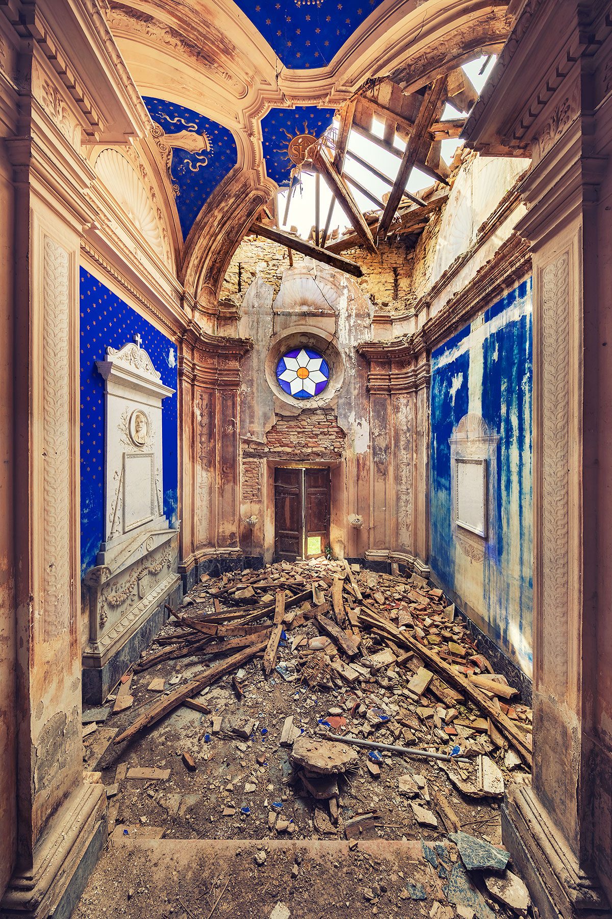 Abandoned blue chapel with a collapsed roof in Italy