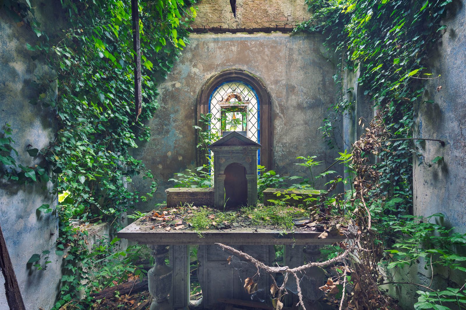 Overgrown chapel of an abandoned villa in Italy