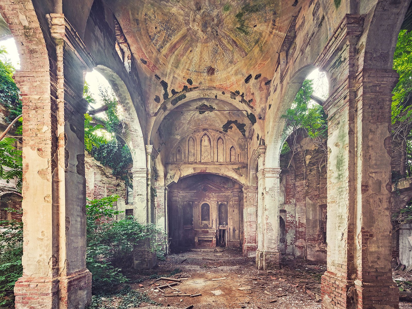 Forgotten church with radiating dome painting in Italy