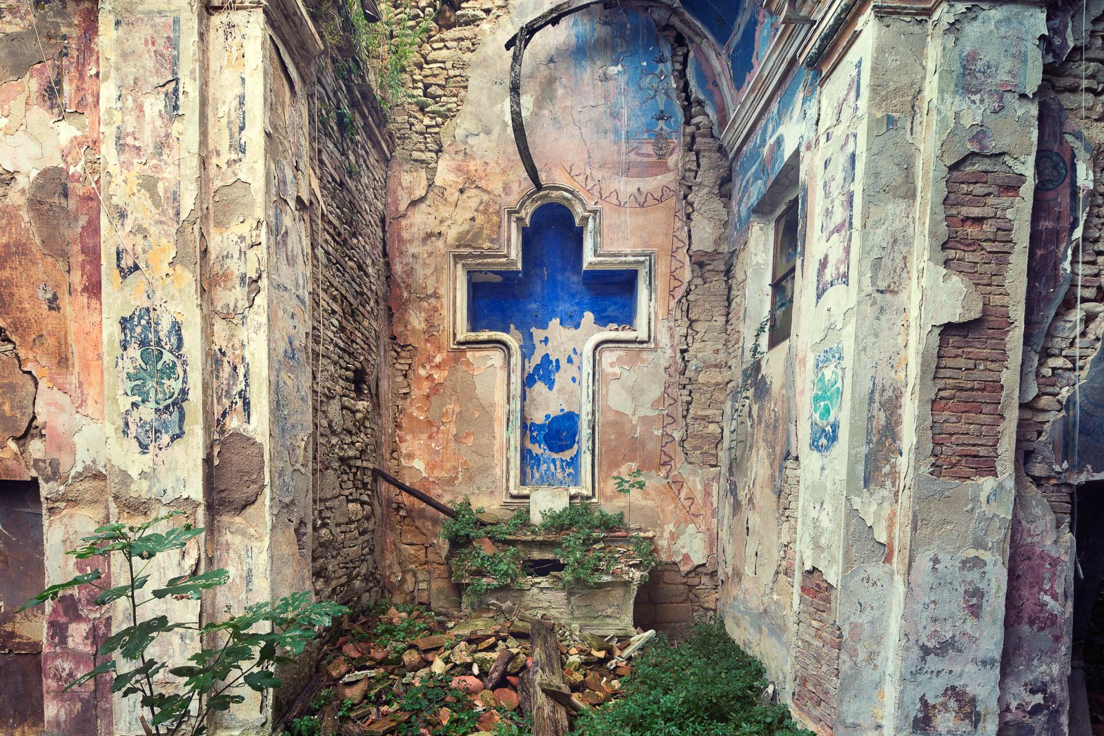 Church ruin with a blue cross in Italy