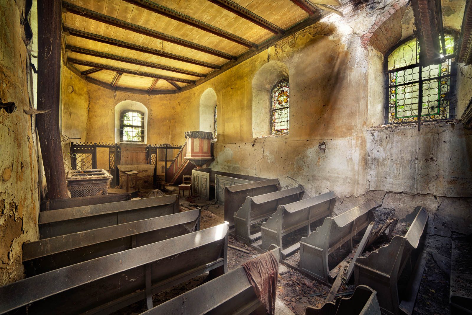 Abandoned cemetery church with rows of pews in Germany