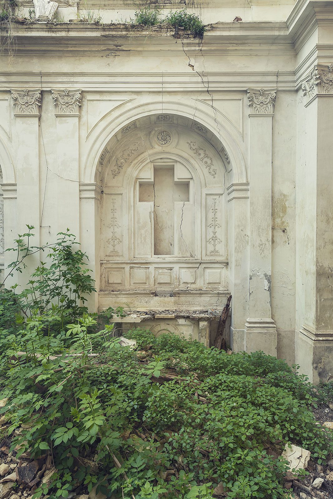 White stone cross in an abandoned church in Italy