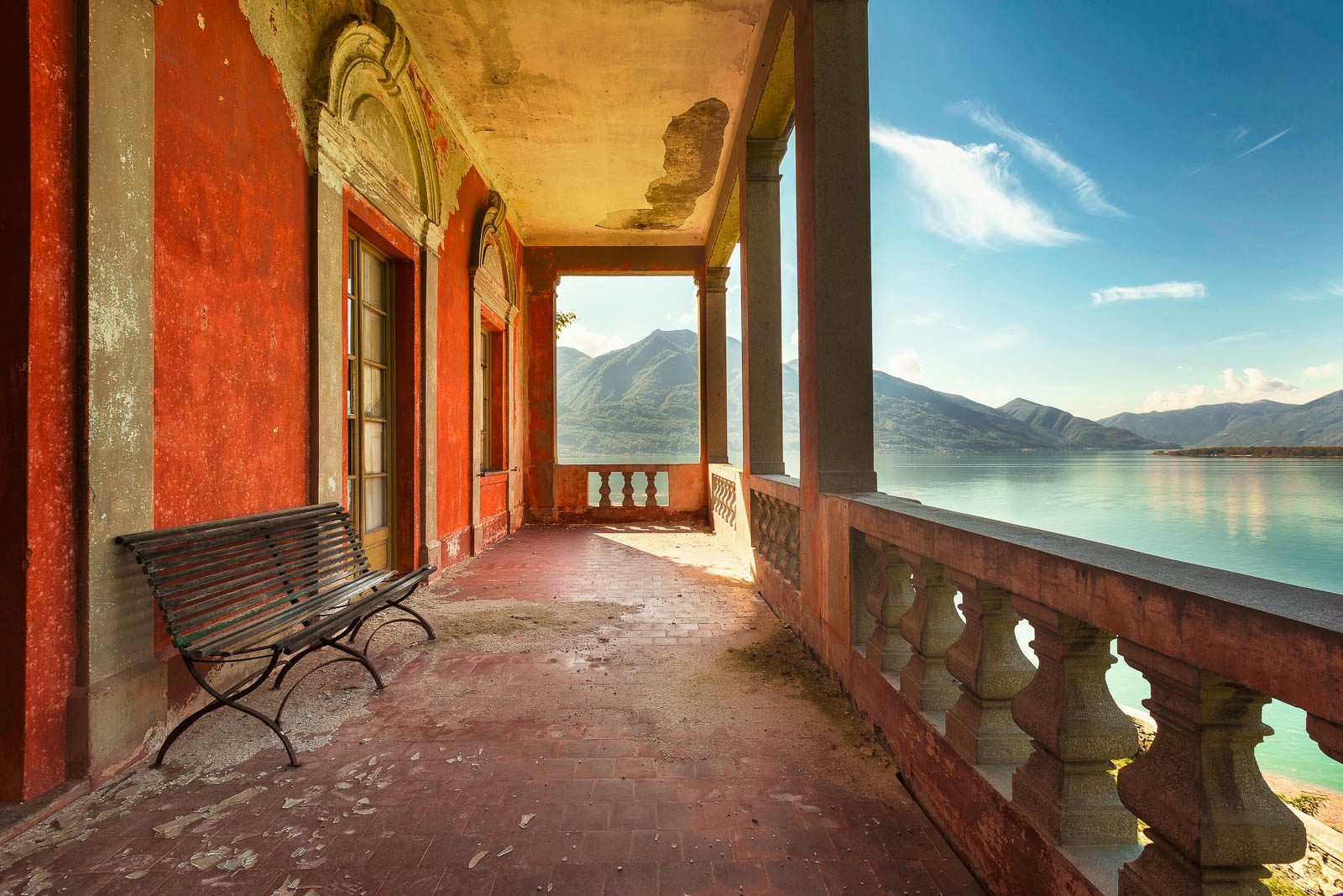 Terrace passage with faded walls overlooking a lake, Italy