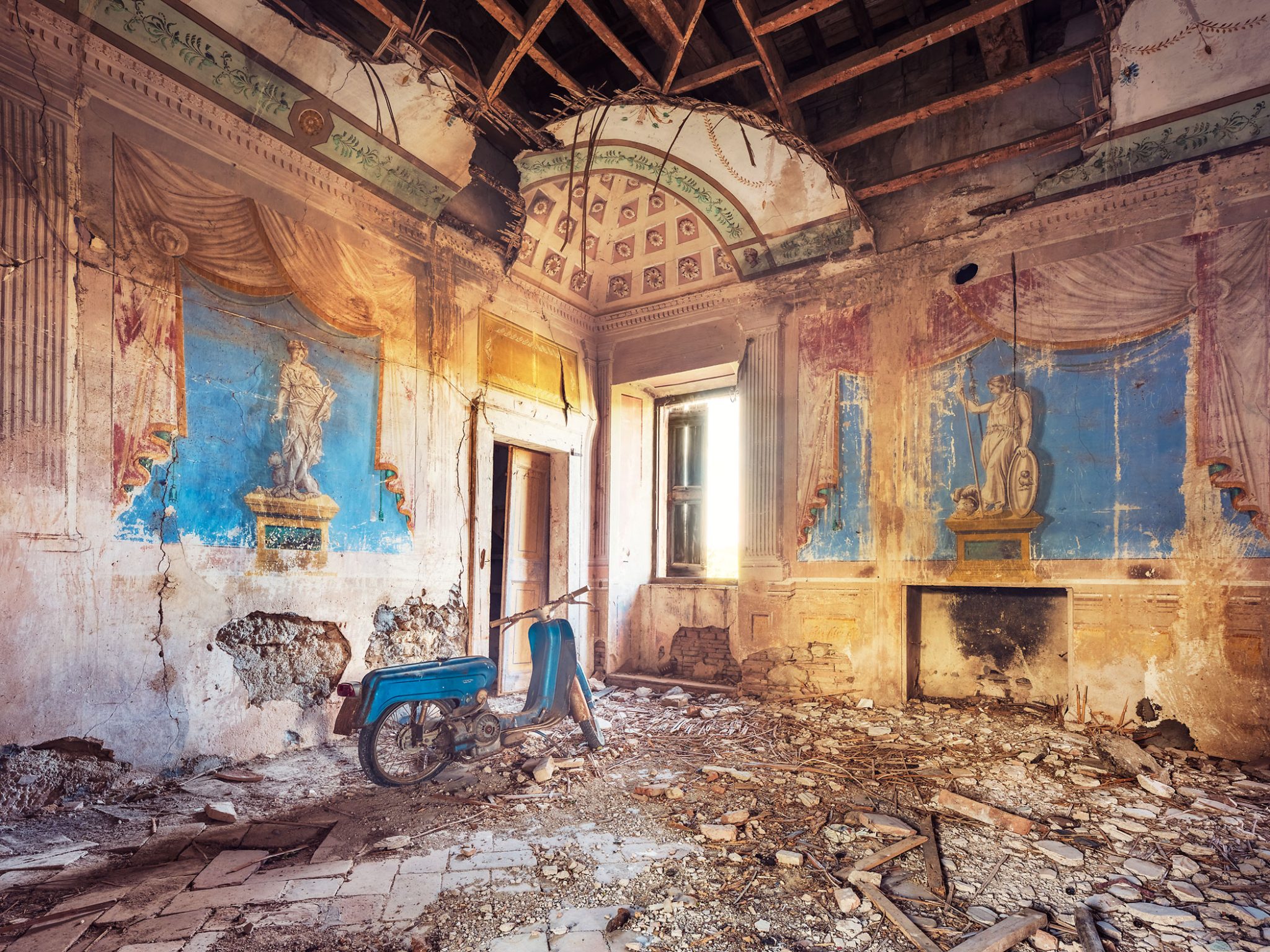 Blue moped in a forgotten frescoed villa in Italy