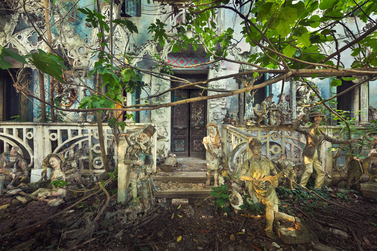 Plant-covered facade with figures at a forgotten artist's house in Italy