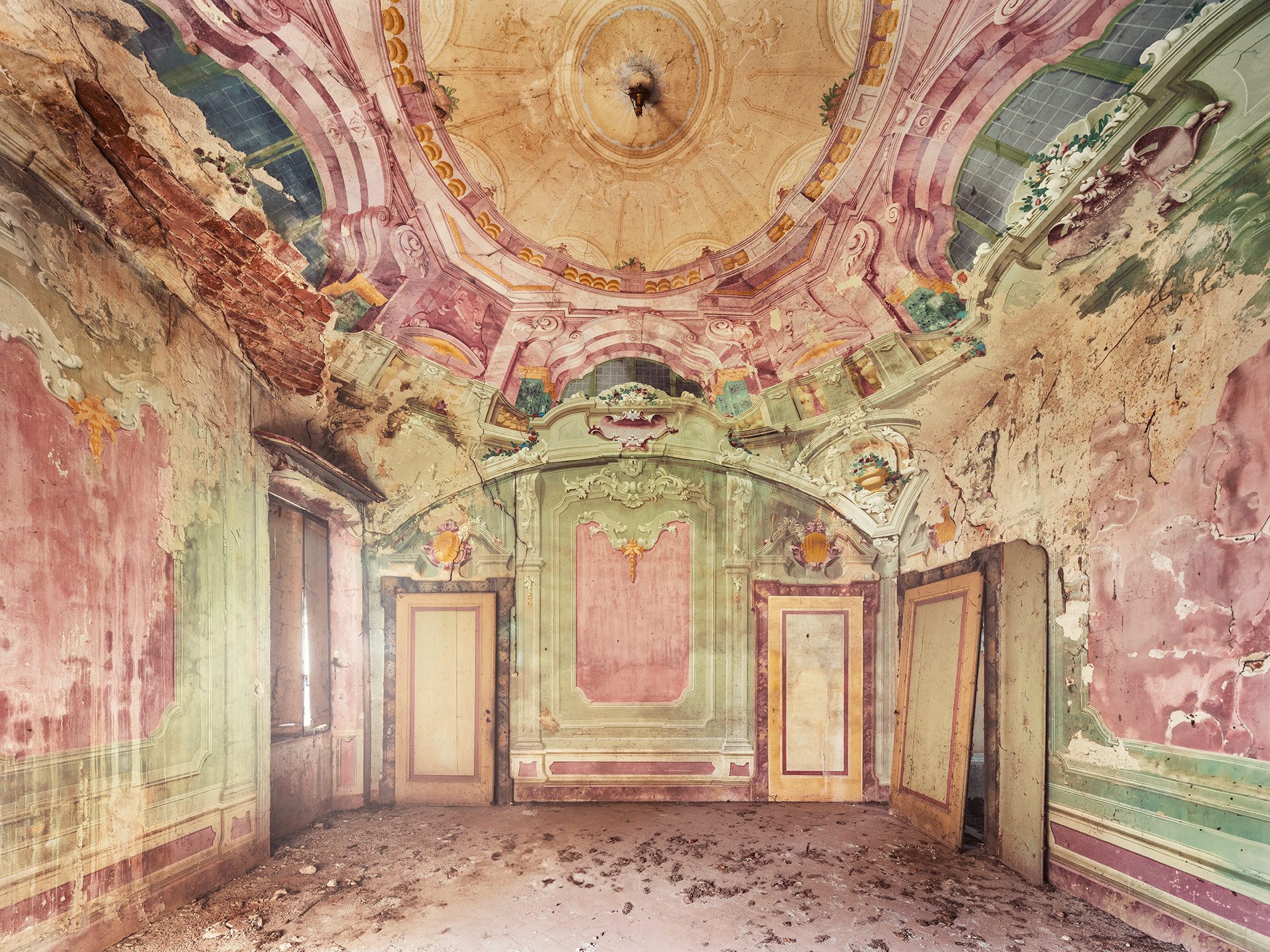 Empty hall with a pastel domed ceiling in a forgotten villa in Italy