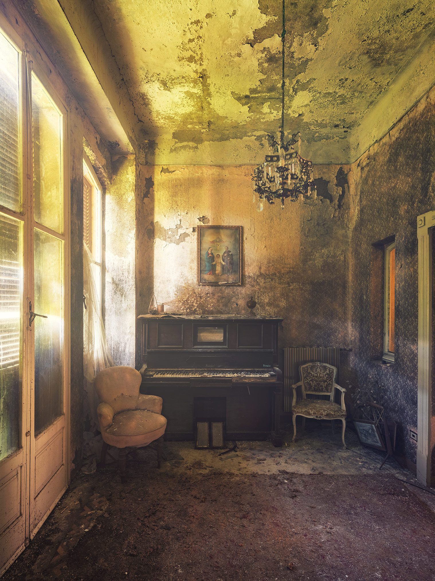 Piano beneath a religious painting in a forgotten villa in Italy