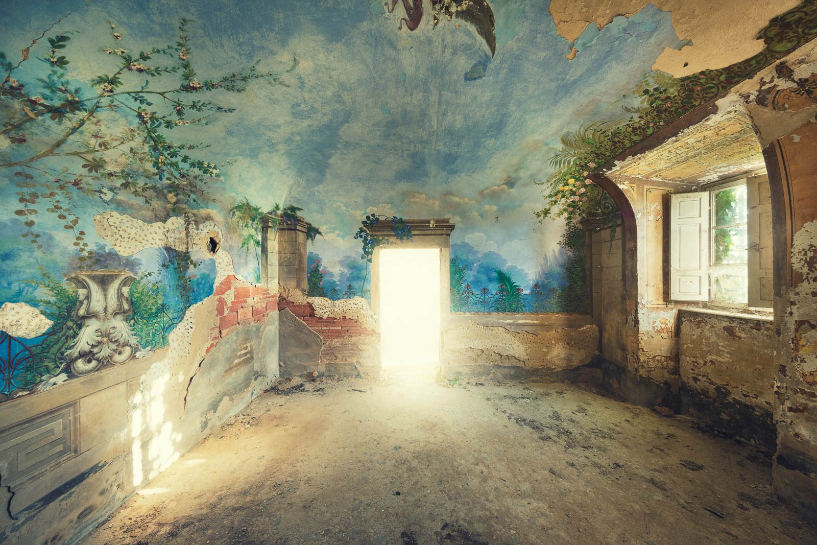 Wall and ceiling fresco with sky and garden motifs in a forgotten villa in Tuscany, Italy
