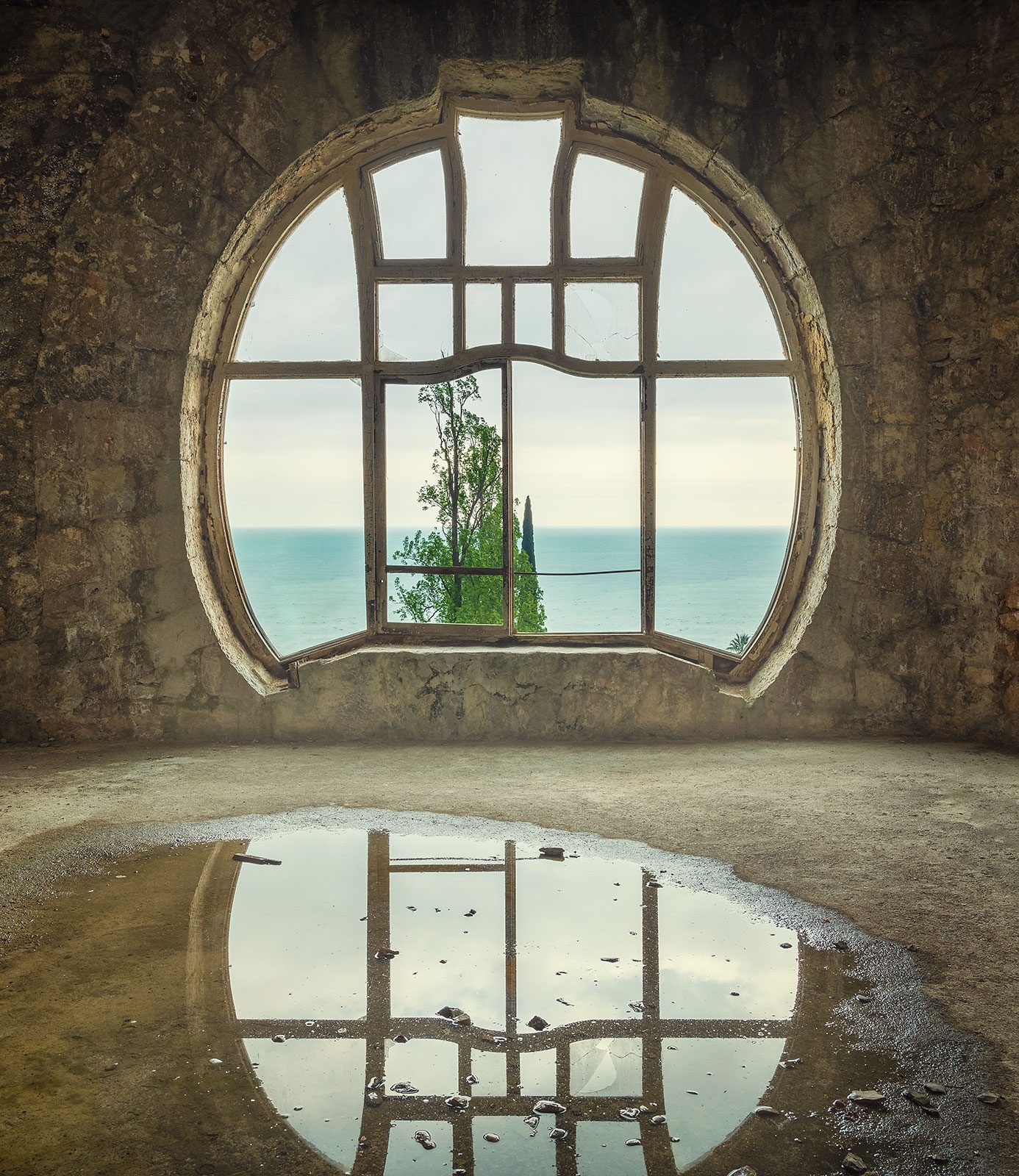 Arched window with a sea view in an abandoned palace in Abkhazia