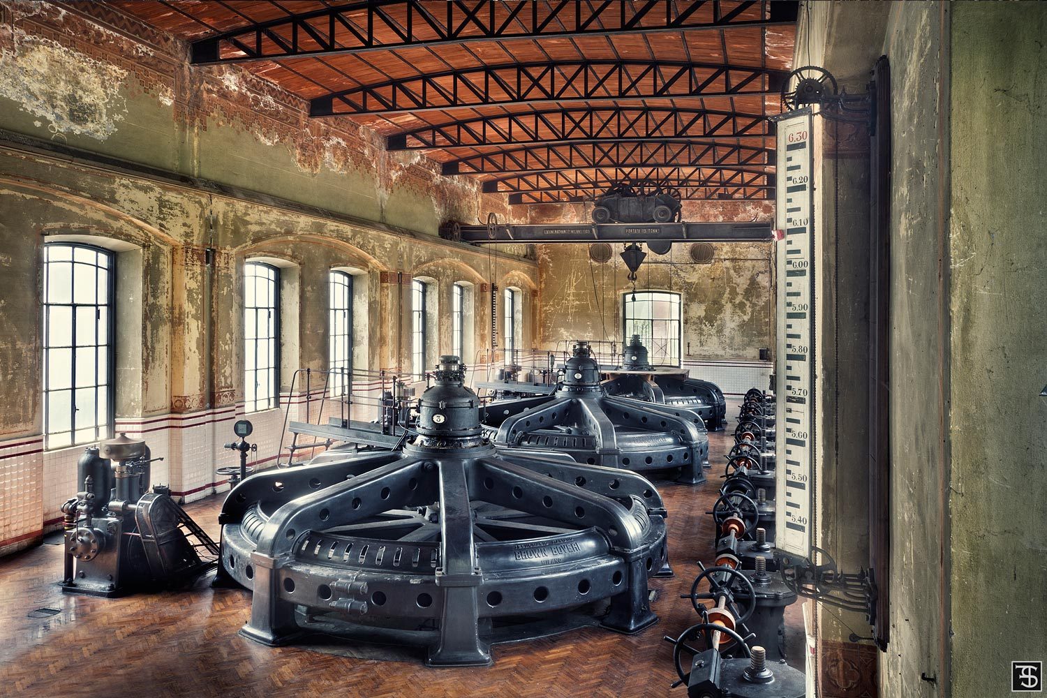 Row of black turbines in an abandoned hydroelectric plant in Italy