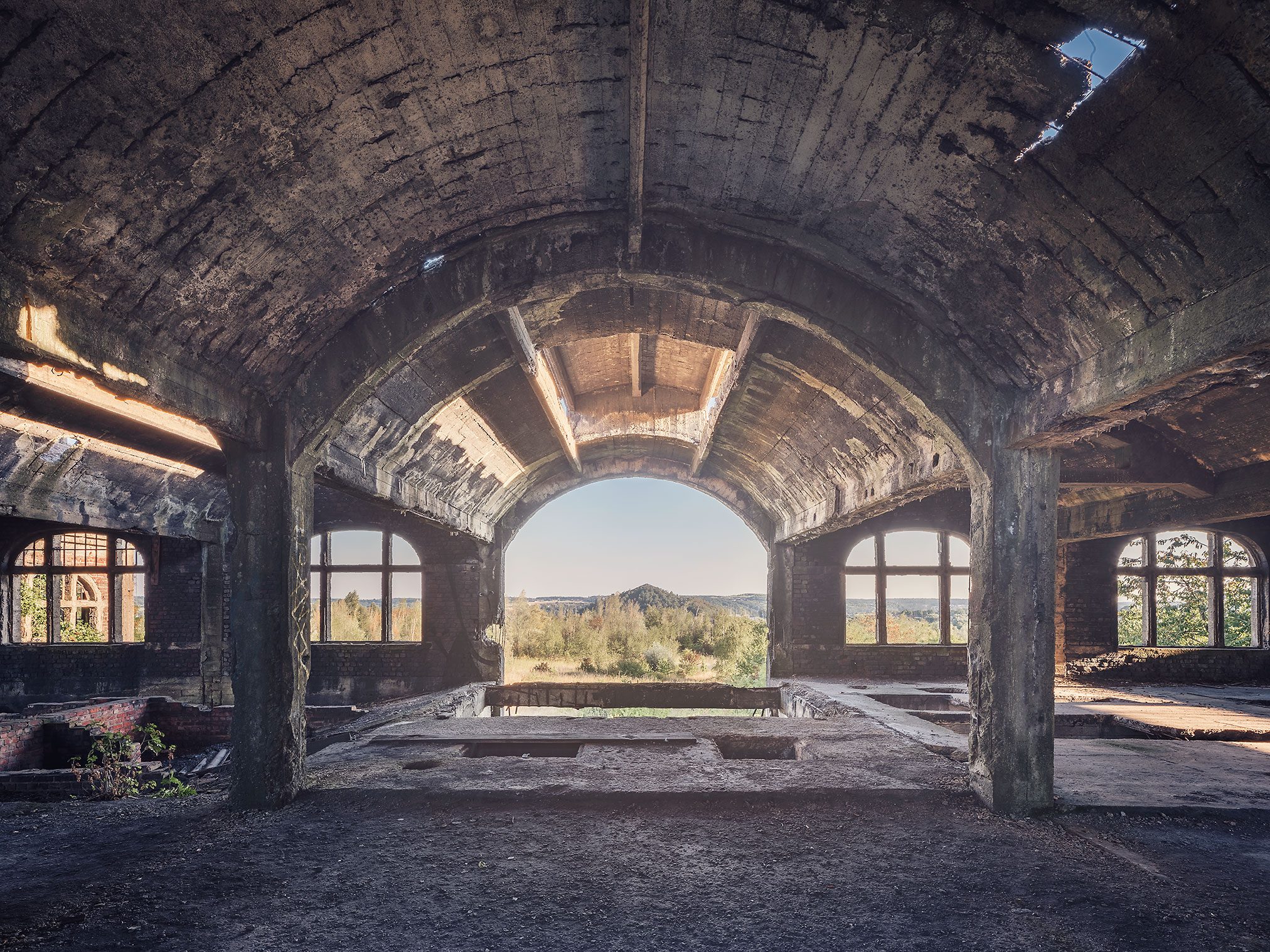 Vaulted room with a view of greenery on a former mining site in Belgium