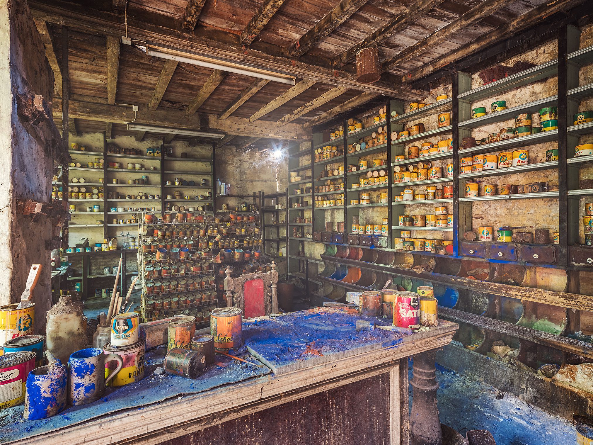 Shelves of old paint tins in an abandoned paint shop in Belgium
