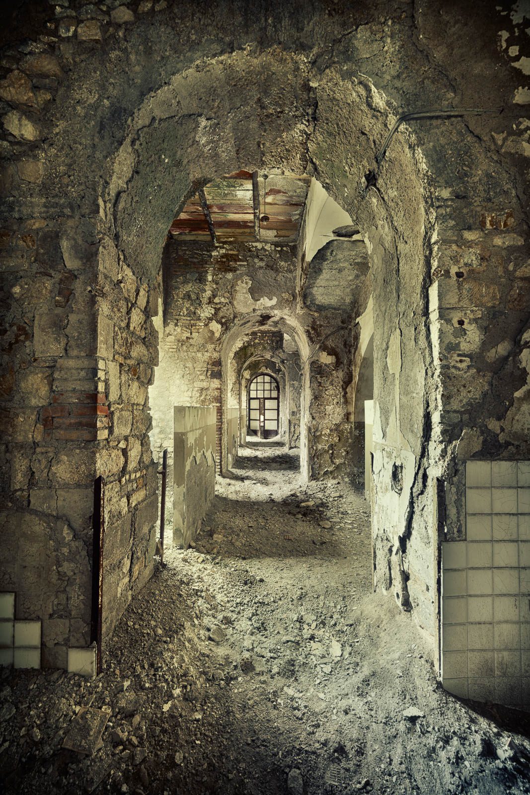 Decayed corridor with arched passageways in a factory in Italy