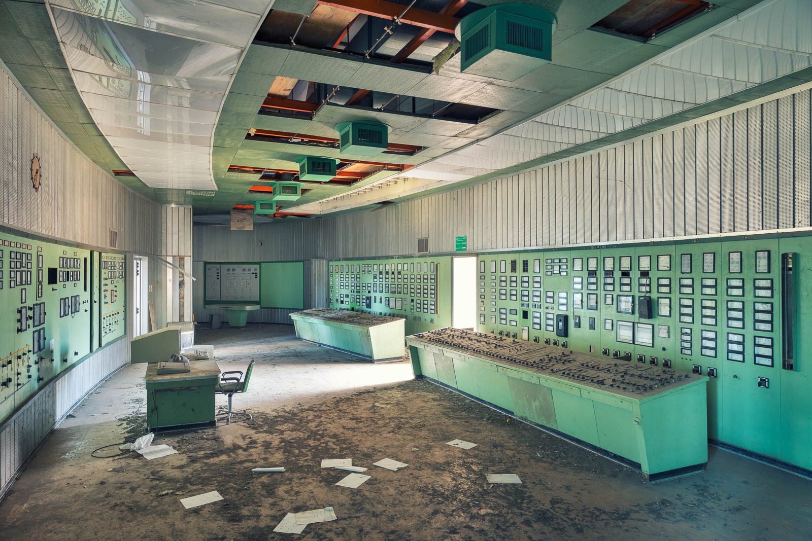 Green-painted control room with switch panels in a power plant in Italy