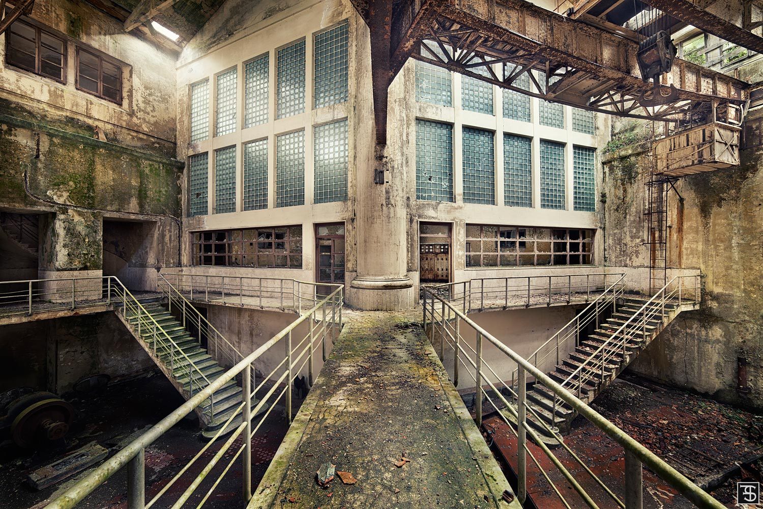 Symmetrical steel stairways in an abandoned hydroelectric plant in Italy