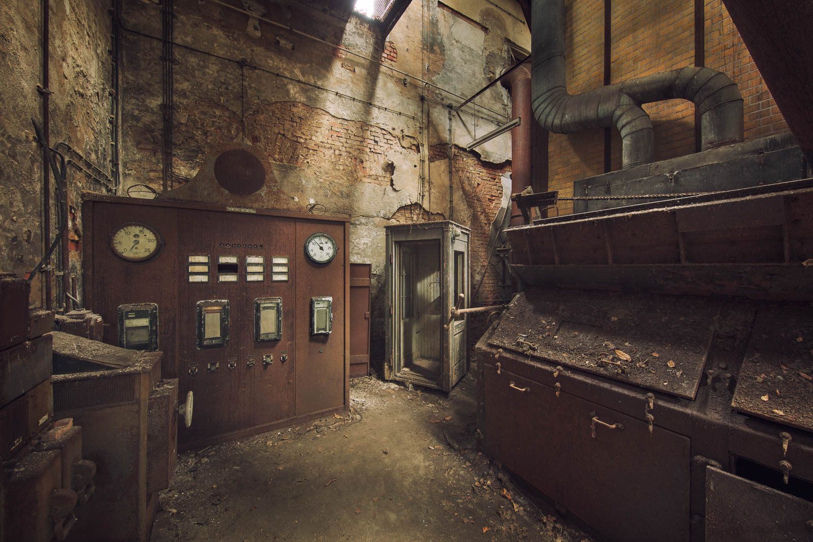 Switch panel with two clocks in the boiler house of an old paper factory in Germany