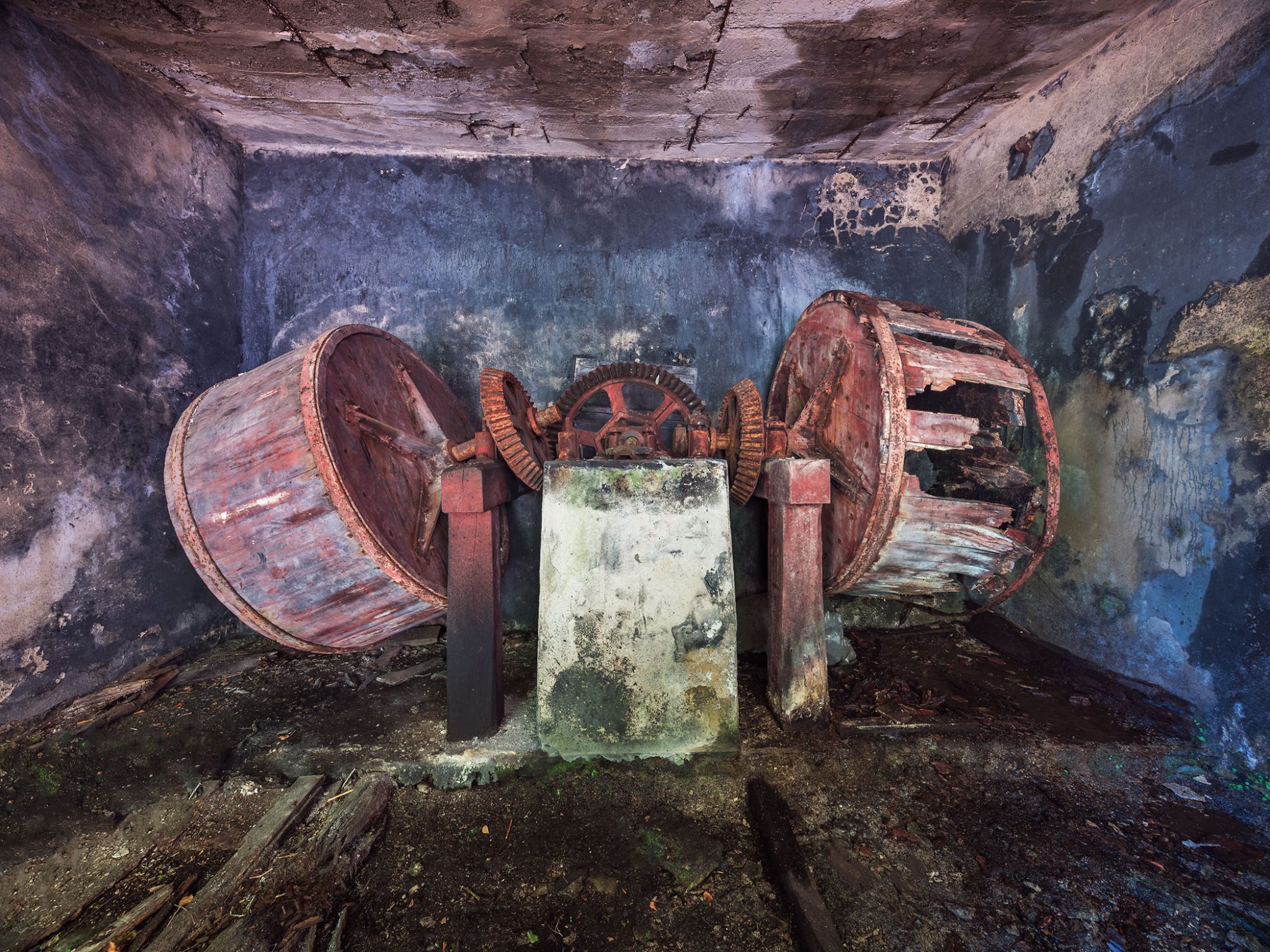 Old grinding drums of a mill in a dark room in Italy