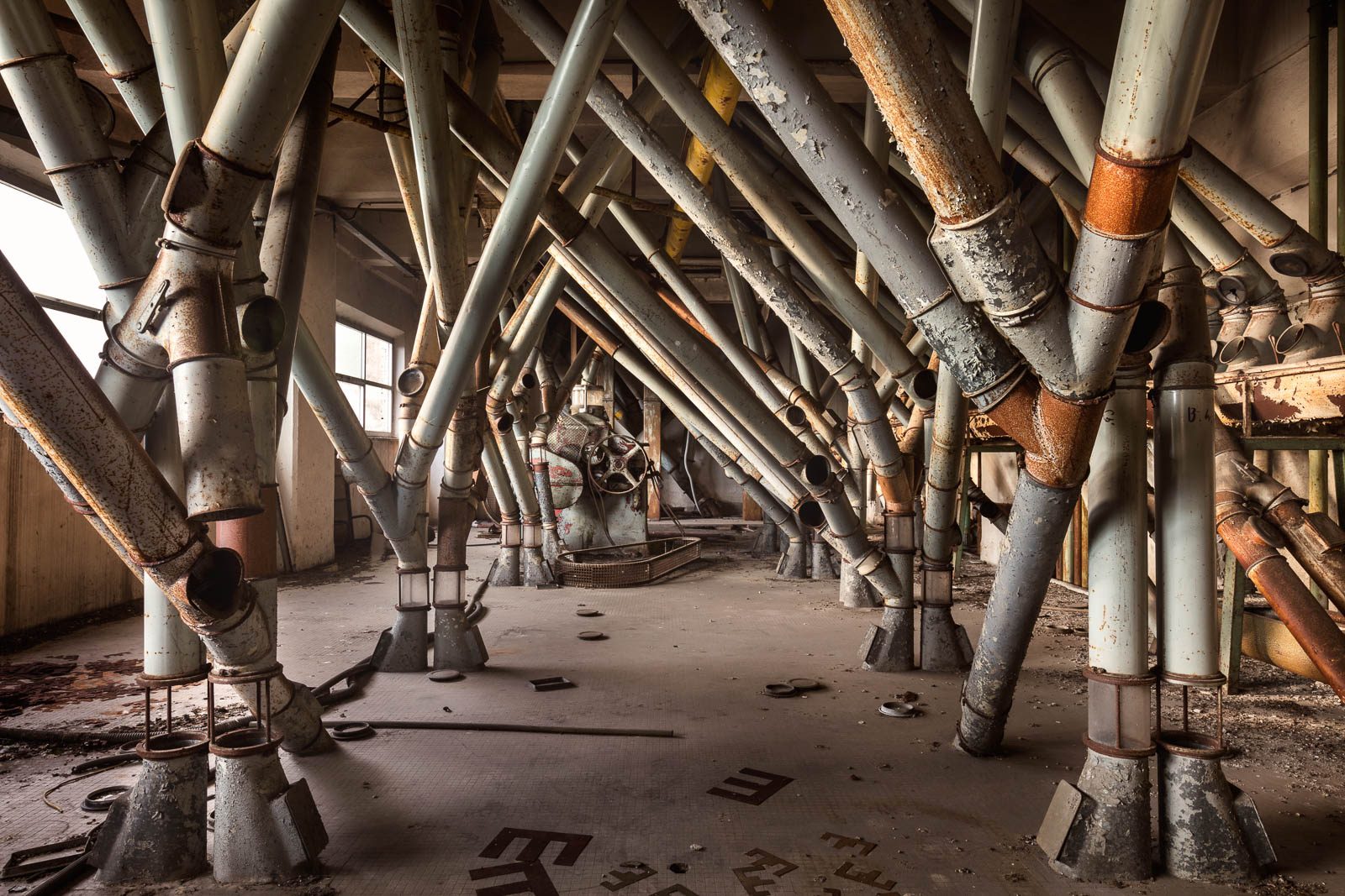 Tangle of pipework in an old mill in Italy