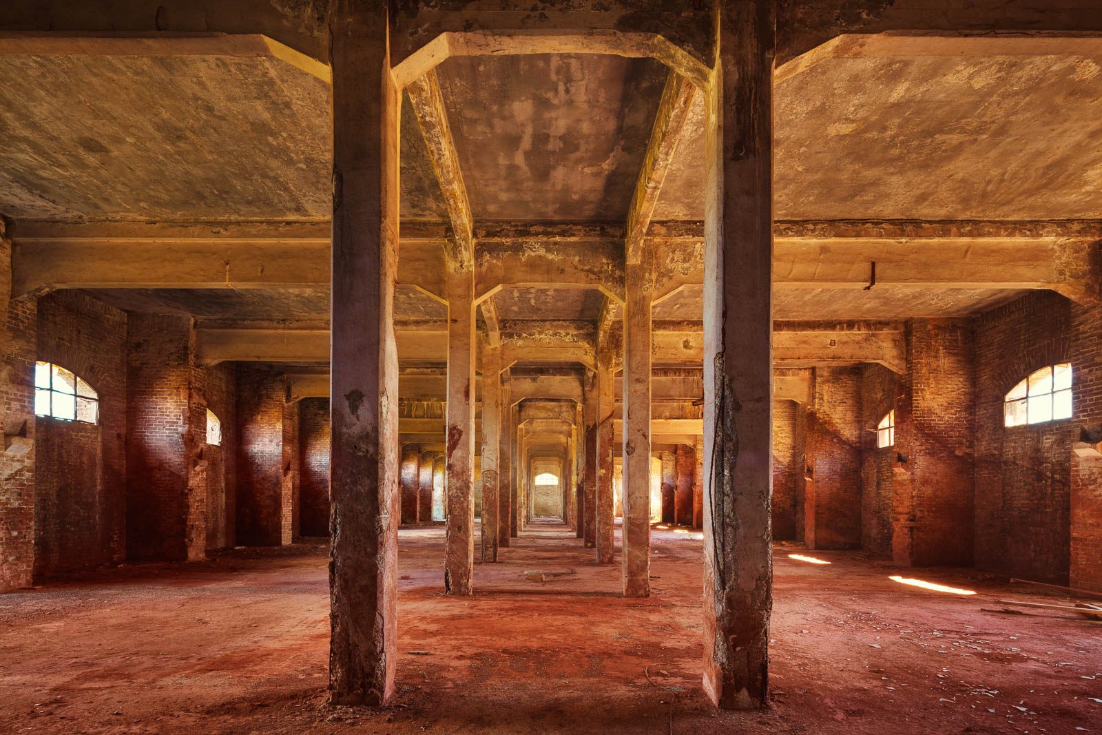 Rows of columns with arched windows in an industrial ruin on the Adriatic coast in Italy