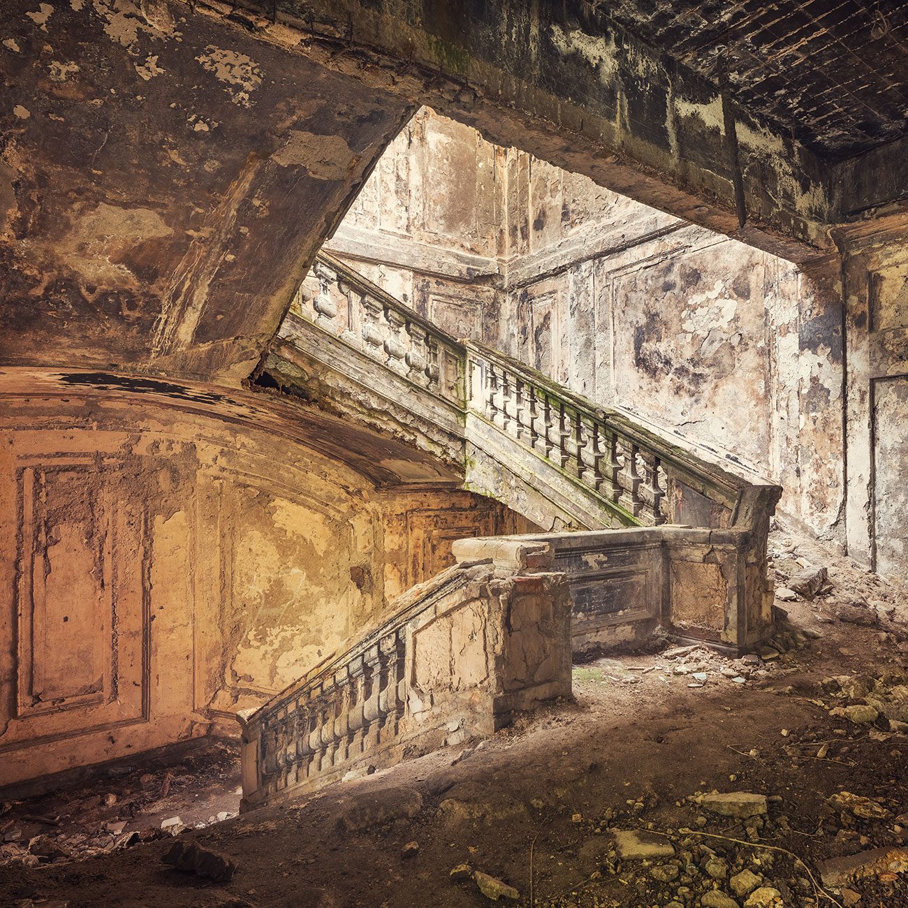 Small balustraded staircase beyond an archway in an abandoned government building in Georgia