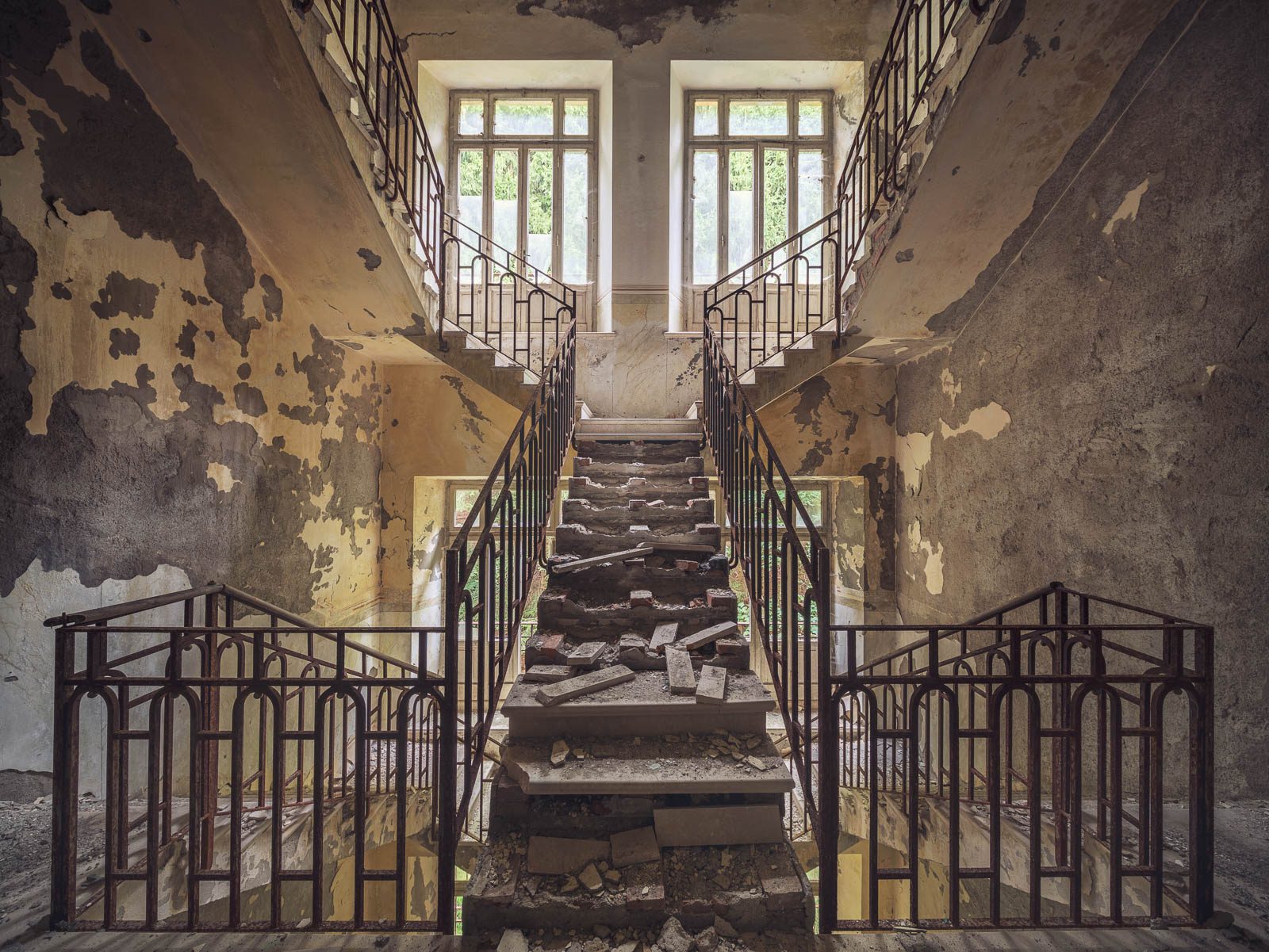 Symmetrische Treppenanlage mit Trümmern auf den Stufen in einem vergessenen Sanatorium in Italien