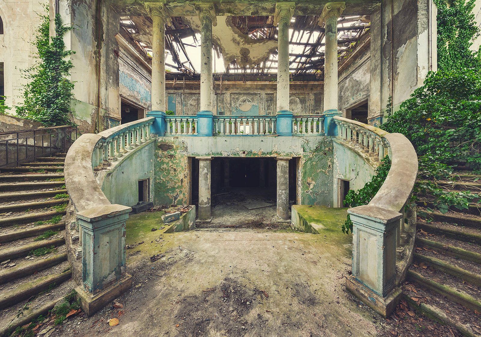 Curved double staircase in the hall of an abandoned house of culture in Georgia