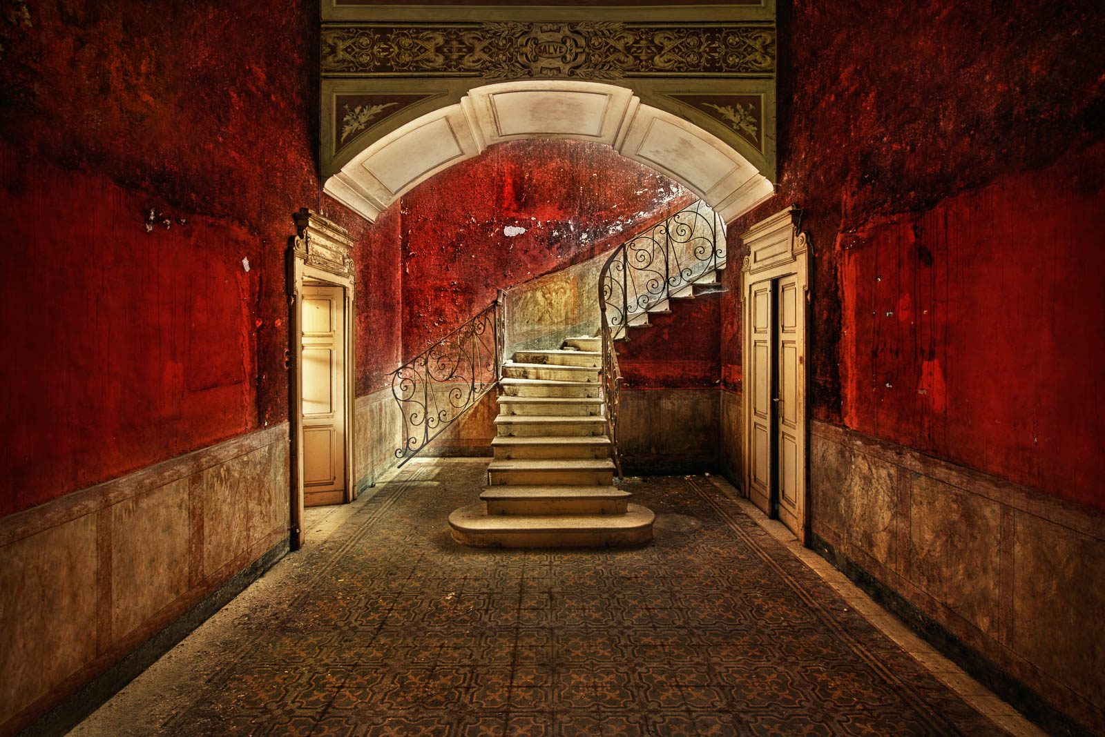 Curved staircase before red painted walls in a wine estate in Switzerland