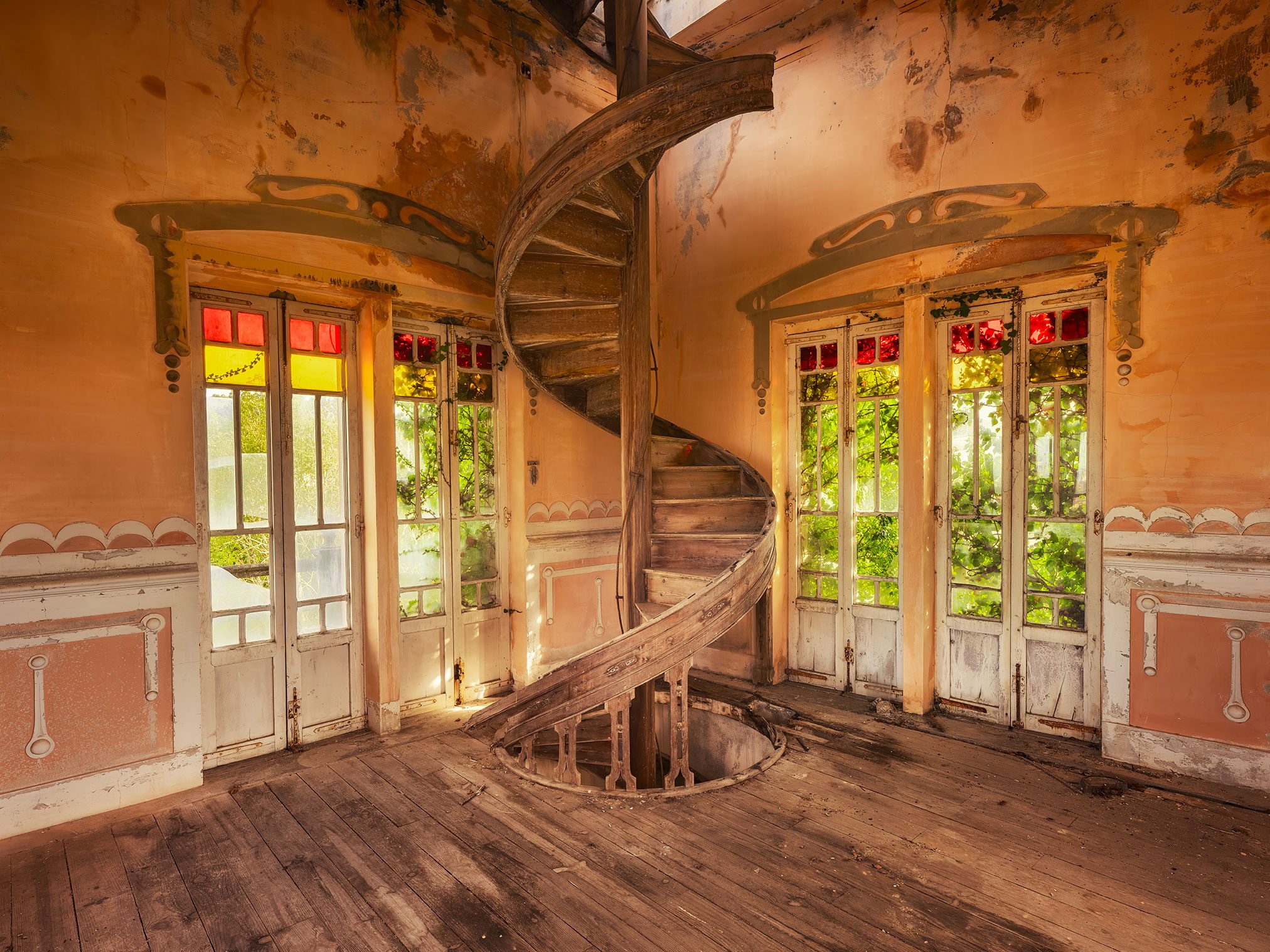 Wooden spiral staircase in an abandoned Art Nouveau villa in Spain
